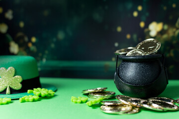 Cauldron, Shamrocks and green hat against green background.