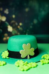 Shamrocks and leprechaun hats on green background with Copy space.