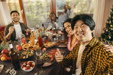 Happy people taking selfie photo sitting on holiday dinner party at home and looks camera with smile
