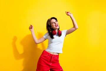 Photo of positive cheerful woman headphones on neck dancing look at black friday promo empty space...