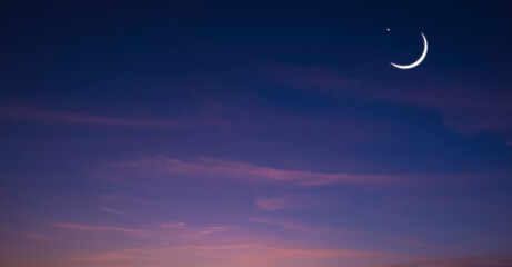 Obraz na płótnie Canvas Crescent Moon and Star on panoramic dark blue Twilight Sky, Ramadan Night sky background design for Ramadan Kareem, Eid Mubarak, Eid al adha, Eid al fitr, Islamic New Year