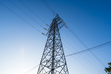 High voltage electric pole under blue sky