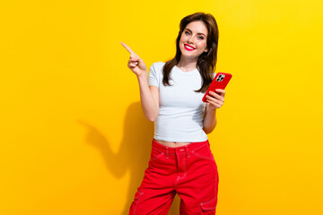 Photo of intelligent woman dressed white t-shirt indicating at promo empty space hold smartphone...