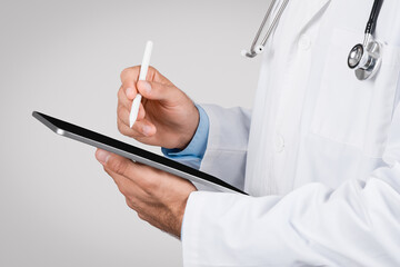 Doctor using a digital tablet with stylus pen, closeup