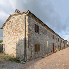 old tuff houses on tile paved street at medieval village, Sovana, Italy