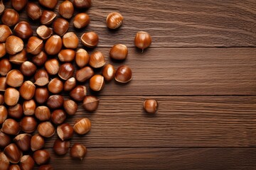 hazelnuts spilled on a wooden table - overhead view