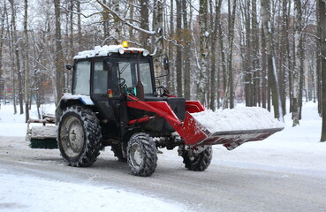 Snow removal with special equipment on the road, Bolshevikov Avenue, St. Petersburg, Russia,...
