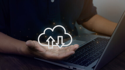 Virtual cloud in hand with laptop on table, cloud computing technology for uploading or downloading data, wireless communication Technology concept business, internet data collection