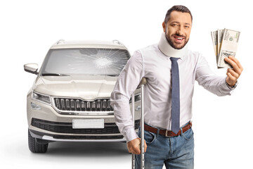 Injured man in a car crasg with a cervical collar leaning on crutches and holding stacks of money