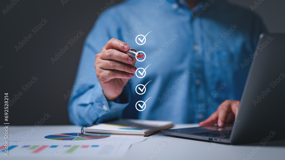Wall mural Businessman use pens to confidently mark choices on their business checklist, embodying a strategic decision-making process with each checked checkbox. - Wall murals