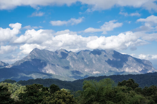 View Doi Luang Chiang Dao mountain with white clouds on blue sky background in the morning at Chiang Mai , Thailand