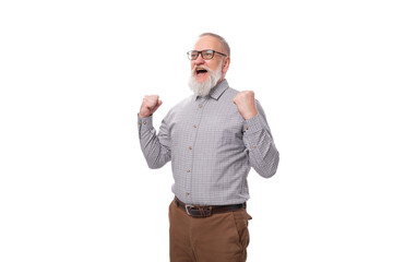 successful grandfather with a gray beard and mustache in glasses dressed in a shirt and trousers on...