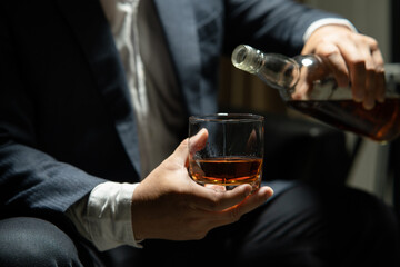 Barman pouring whiskey whiskey glass..