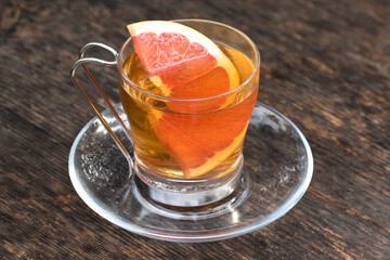 A cup of herbal tea of the Akoluk thyme (Origanum micranthum) with a grapefuit slice in it