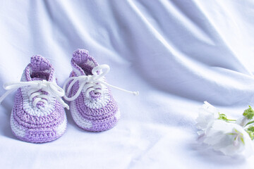 Knitted booties socks on a white background for newborns