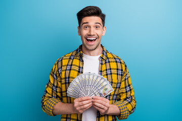Photo of ecstatic astonished man with bristle dressed plaid yellow shirt hold money staring open...