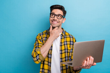 Portrait of smart guy with stubble wear checkered shirt in glasses holding laptop look empty space...