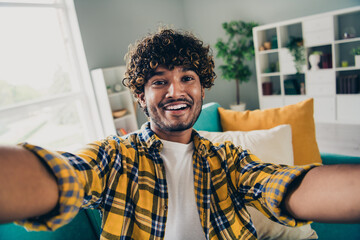 Portrait of positive nice young man beaming smile take selfie recording video free time chill house...
