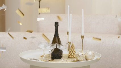 Preparing for a holiday or Christmas with a bottle of champagne and festive glasses. Sparkling wine...