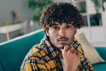 Portrait of pensive intelligent person sit sofa arm touch chin contemplate decide spend pastime day...