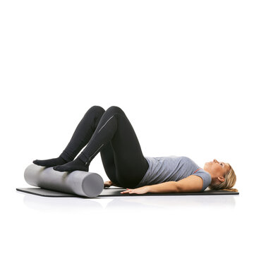 Pilates, foam roller and woman in core workout, exercise or wellness for sports rehabilitation on floor. Ground, mockup space and studio athlete fitness, training and lying on mat on white background