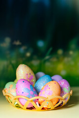 Happy Easter day decoration colorful eggs in nest on green background with copy space.
