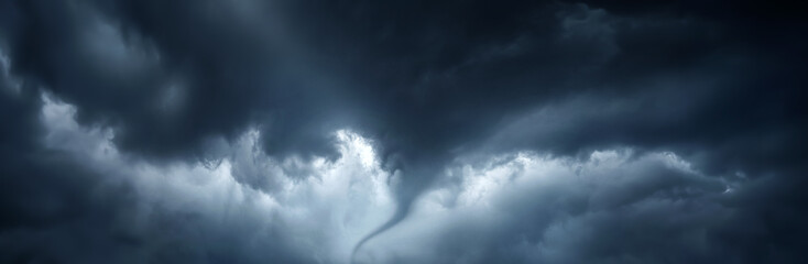 The typhoon is born, a tornado in a stormy dark sky with black clouds and a strong wind. Concept on...