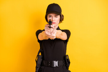 Photo of serious confident focused policewoman aiming at you with pistol enforcement isolated on...