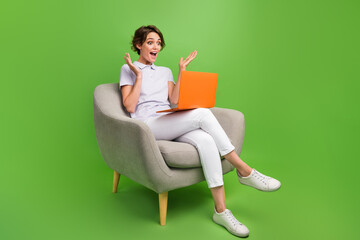 Full length photo of cute impressed girl dressed grey polo online shopping modern device isolated green color background