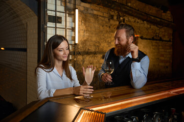 Man picking up woman in bar starting nice conversation