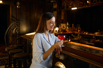 Happy smiling woman rests in bar