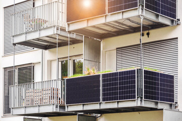 Solar Panels on Balcony Railings of Modern Apartment Building with Sunlight. Modern Balcony with...
