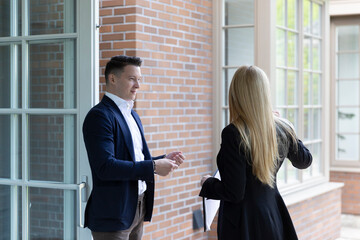 Real estate agent visits customer to assess residence before selling on market. Realtor supports...