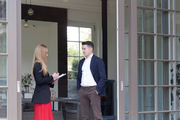 Blonde estate agent to access residence for selling via agency on local estate market. Businessman...
