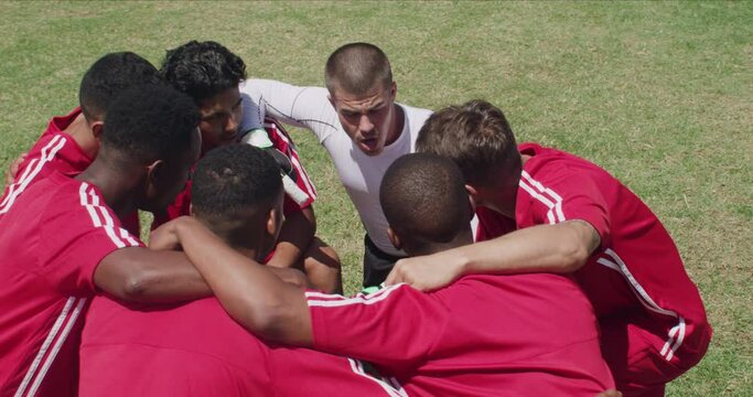 Team, soccer players and huddle on field, boys and drone with talking, support or solidarity. Energy, sports and friendship, scream and serious for motivation, ready for game or physical activity