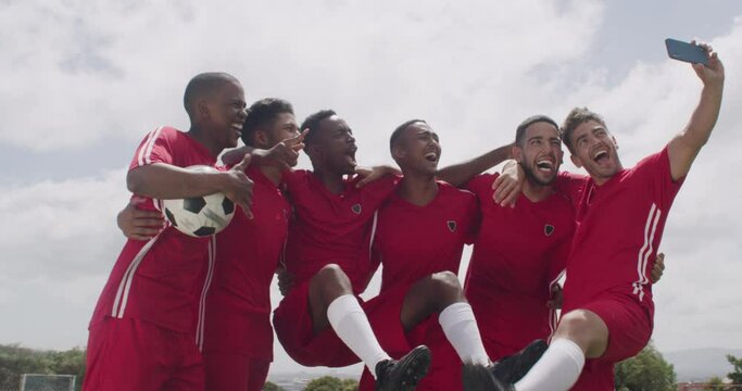 Soccer, selfie and team of men on field for celebration for game, match and competition outdoors. Sports, excited and athletes take profile picture, photo or memory for training, fitness and exercise
