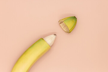 Male circumcision concept, banana with skin cut off - obrazy, fototapety, plakaty