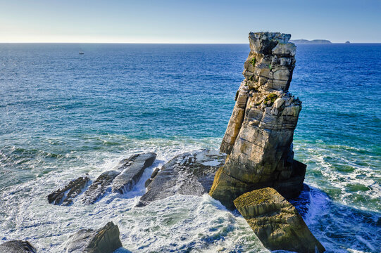 Sea waves and Nau dos Corvos rock near Peniche peninsula, Portugal at