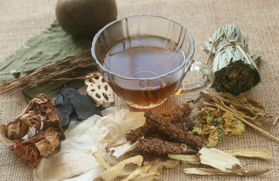 a glass cup of herbal juice or Jab-Liang juice with its herb ingredient. ingredients of Chinese herbal juice for internal body heat or internal hot relief. Jab-Liang juice. 