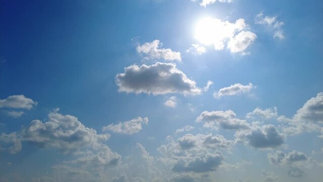 Altocumulus clouds moving in the blue sky during bright sunny summer day, timelapse