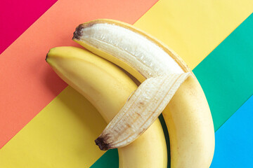 LGBT love concept, two bananas lie on the rainbow flag, a symbol of male love, close-up - 692609269