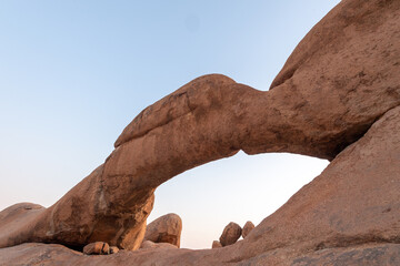 Sunset over the rock arch near Spitzkoppe, a famous granite peak in the center of namibia.