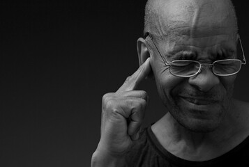 deafness suffering from hearing loss on grey black background with people stock image stock photo	