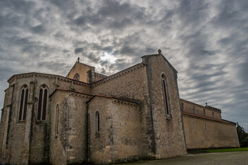 Fototapeta na wymiar Buttress and transept of the gothic Santa Clara church in perspective with cloudy sky, Santarém PORTUGAL