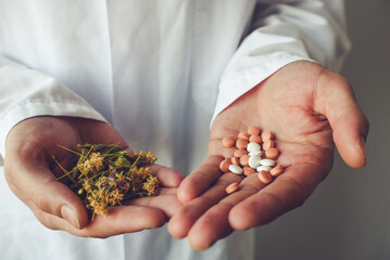 Herbs and synthetic medicine in doctor's hands