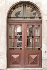 Fototapeta na wymiar The vintage design brown wooden front door of an old house