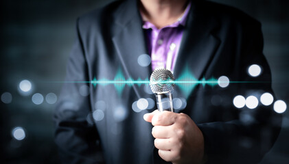 Man in business suit holding a microphone conducting a business interview, journalist reporting, public speaking, press conference, MC, Public speaking and giving speech in suit for audience concept.