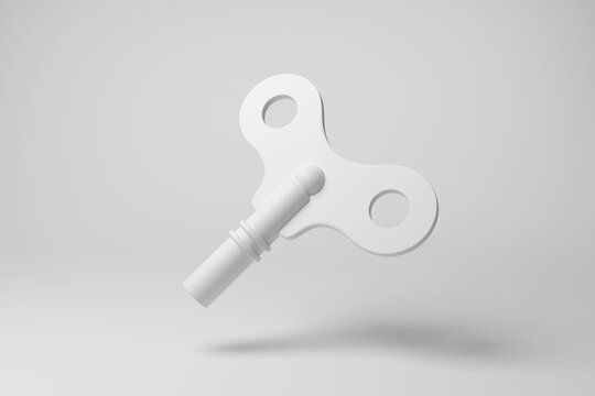 White wind up key floating in mid air on white background in monochrome and minimalism. Illustration of the concept of wind up tin toys and mechanical clockwork
