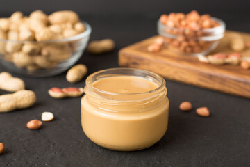 Jar of peanut butter on concrete background