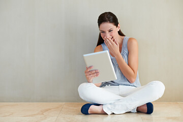 Happy woman, tablet and laughing for funny joke, social media or meme sitting on floor at home....